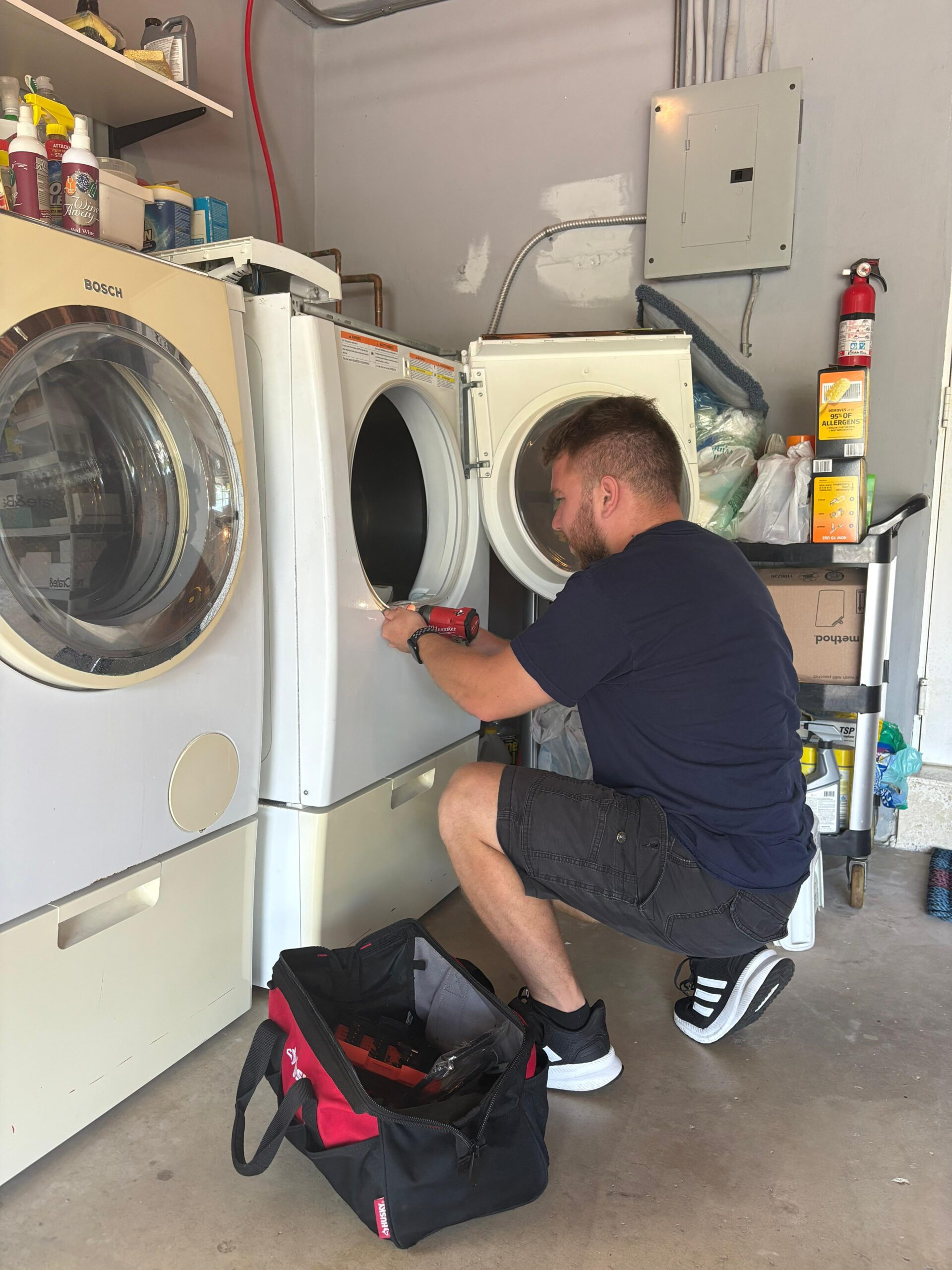 Fix Masters technician performing dryer repair in Broward County home
